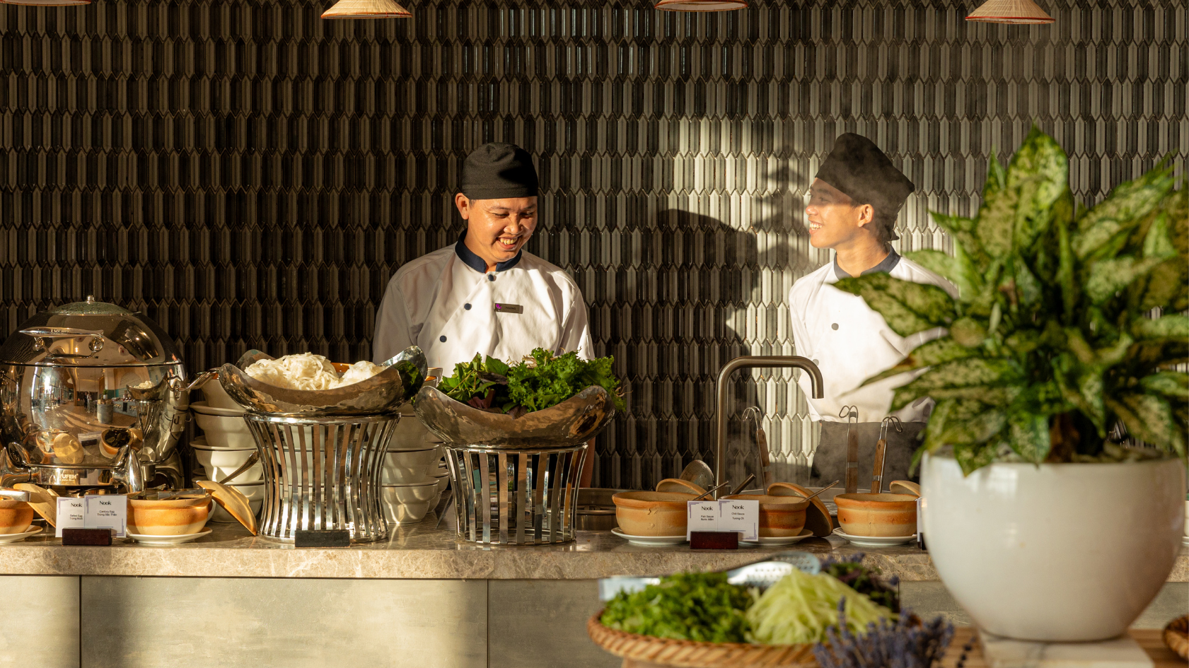 Two chefs at the Nook restaurant buffet counter.